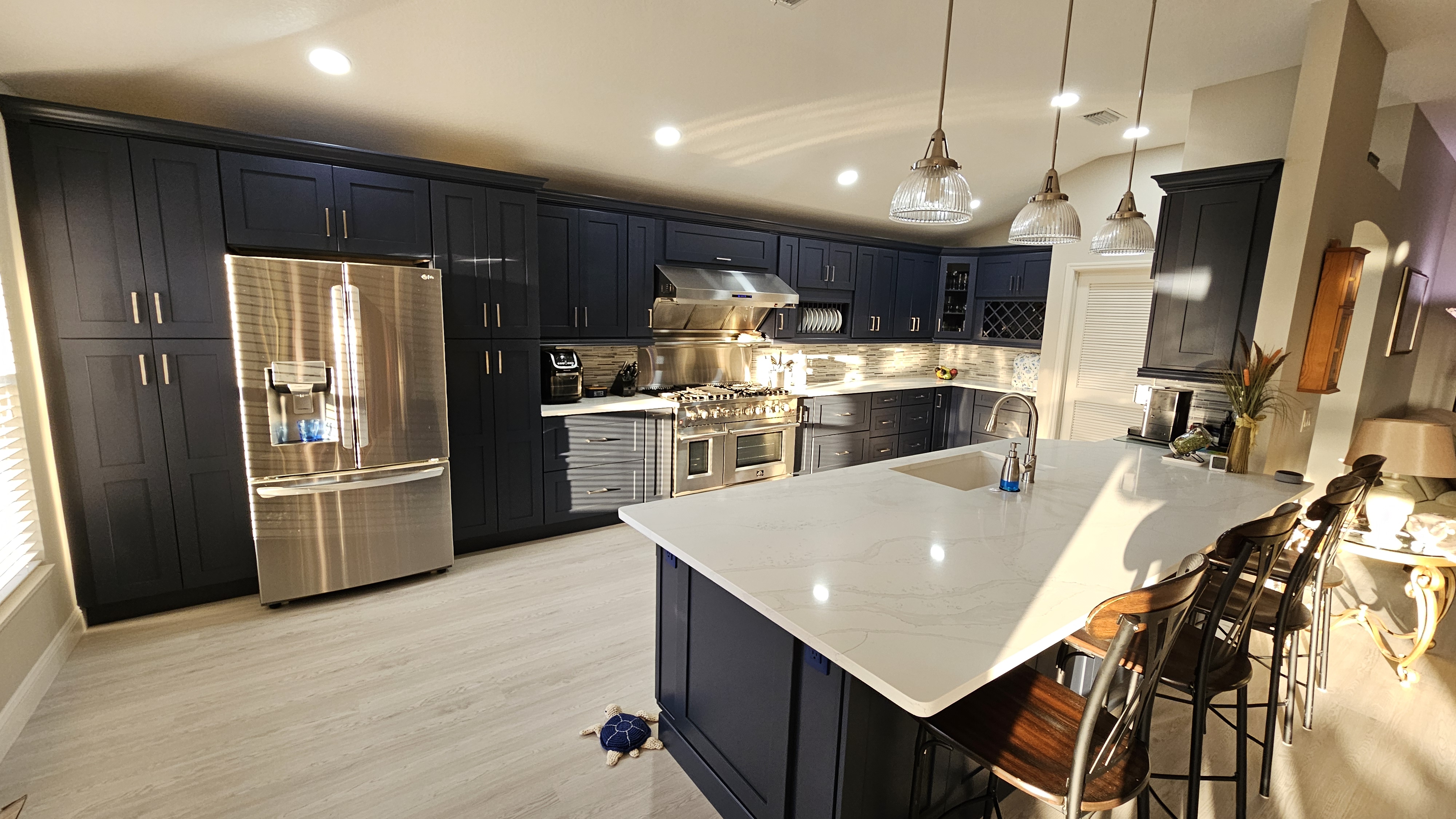Glide-Lock kitchen - Navy Shaker with marble waterfall island and Wolf range